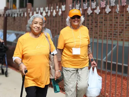 two senior ladies walking outside in Walking Club