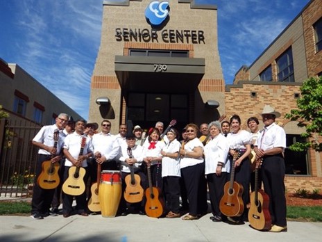 Grupo Renecer, standing outside and smiling with their guitars