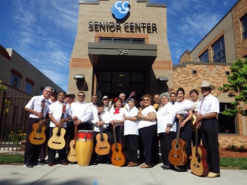 Group Photo of the Senior Center Music Group, Grupo Renecer, standing outside and smiling with their guitars