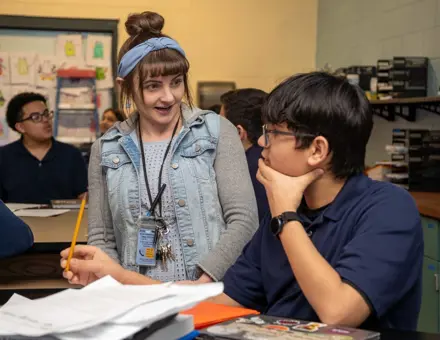 Science teacher teaching a middle school student at Bruce-Guadalupe Middle School in Milwaukee WI