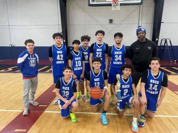 Boys Middle School Basketball Team with their coach in the gym
