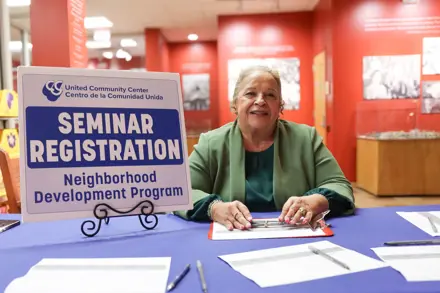 Staff member sitting in the lobby and welcoming first time homebuyers to the seminars